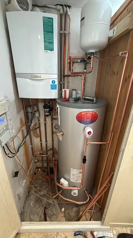 Wall-hung gas boiler with hot water cylinder and copper pipework