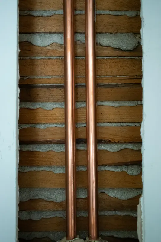 Copper pipework run inside a wall during first fix plumbing
